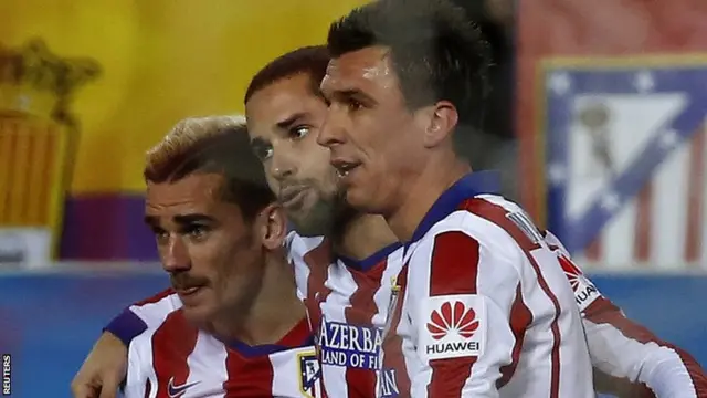 Antoine Griezmann (L) celebrates his first goal against Rayo Vallecano with team-mates Mario Suarez (centre) and Mario Mandzukic