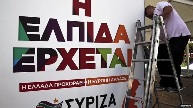 Worker dismantles Syriza party's election kiosk in Athens. 26 Jan 2015