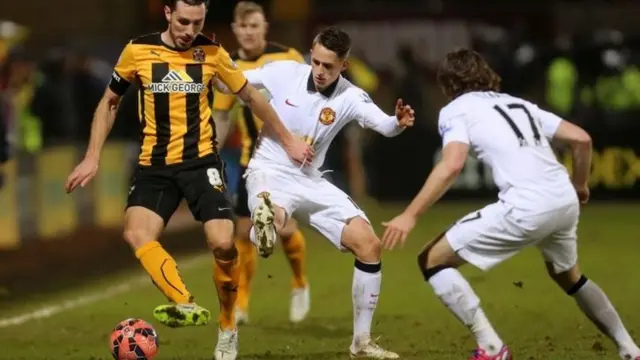 Action from the first match between Cambridge and Manchester United