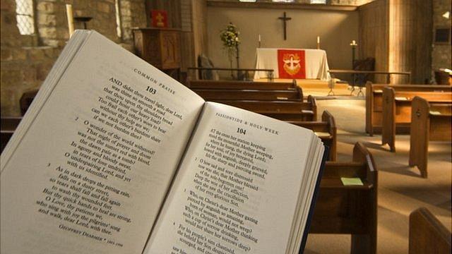 Prayer book held up inside an Anglican church