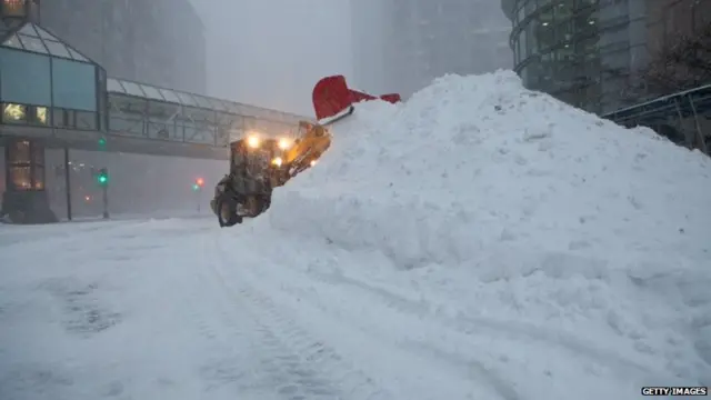 Snow plows work during a blizzard to clear the streets in the Back Bay neighborhood in the early morning on January 27, 2015 in Boston, Massachusetts.