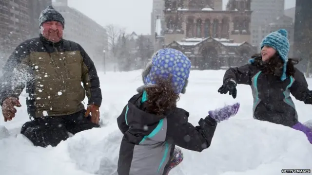 family plays in the snow in Copley Square during the blizzard on January 27, 2015 in Boston, Massachusetts.