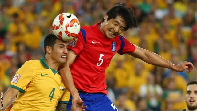 Tim Cahill of Australia and Kwak Taehwi of Korea Republic compete for the ball