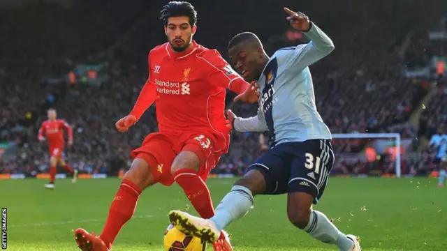 Enner Valencia takes the ball past Emre Can