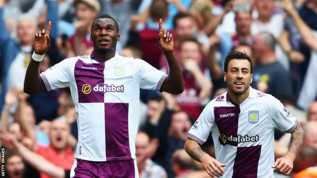 Christian Benteke (left) celebrates scoring at the Emirates