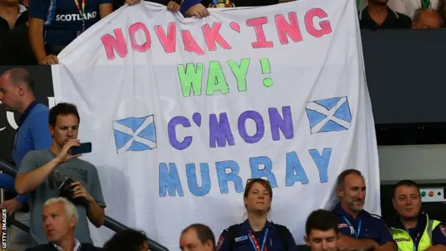 Fans of Andy Murray hold up a banner