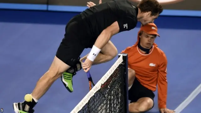 Andy Murray runs near a ball boy