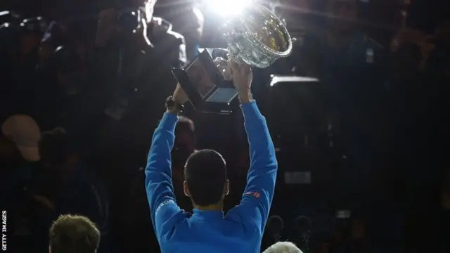 Novak Djokovic lifts the Australian Open trophy