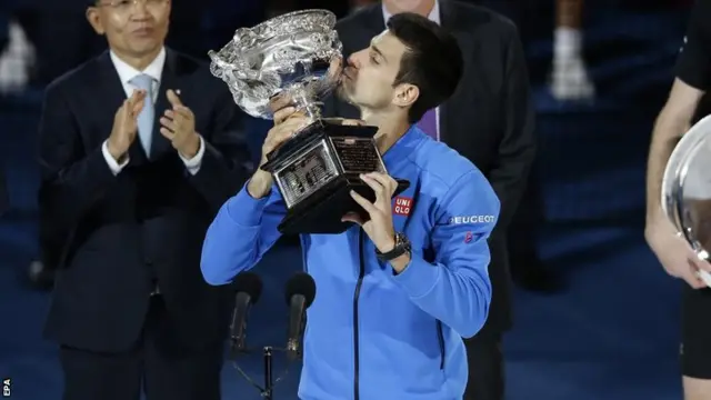 Novak Djokovic celebrates with the trophy