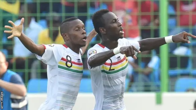 Ibrahima Traore and Lamine Traore celebrate a goal for Guinea