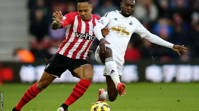 Nathaniel Clyne and Nathan Dyer tussle for the ball