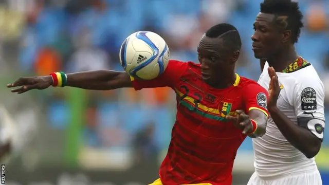 Asamoah Gyan and Djibril Paye battle for the ball