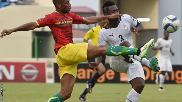 Asamoah Gyan challenges for the ball