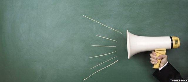 A loudhailer next to a blackboard