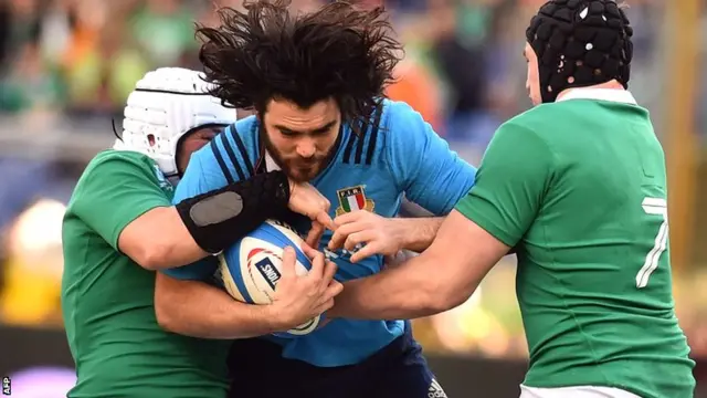 Italy's Luke McLean is wrapped up by the Irish defence