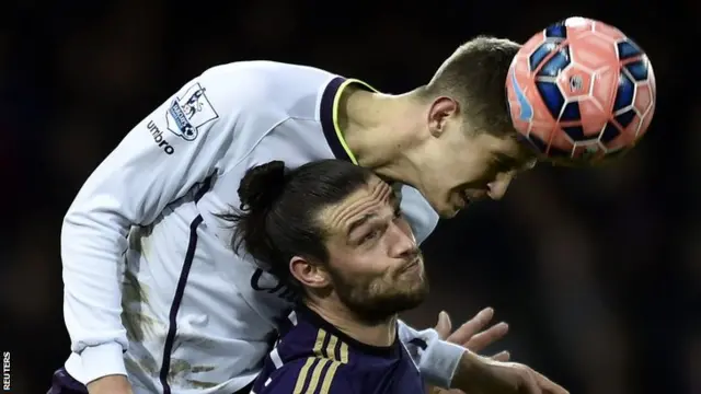 Everton defender John Stones in action with West Ham forward Andy Carroll