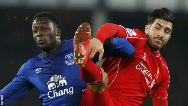 Everton's Romalu Lukaku and Liverpool's Emre Can go for the ball