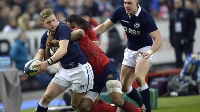 Scotland fly-half Finn Russell is tackled