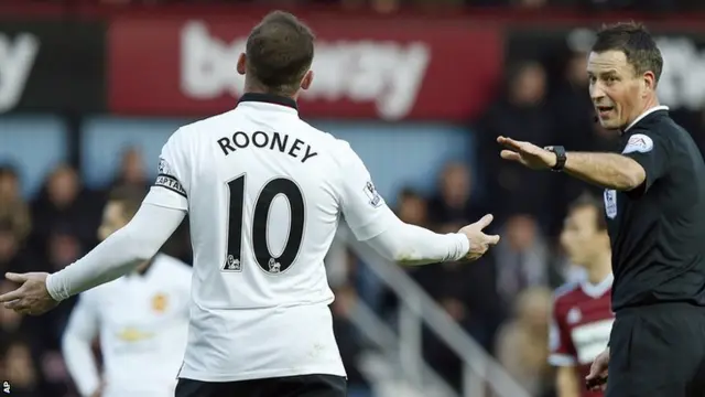 Referee Mark Clattenburg tries to calm Wayne Rooney