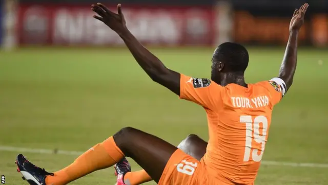 Yaya Toure gestures to the referee