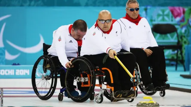 Gregor Ewan delivers a stone at the Sochi Winter Paralympics