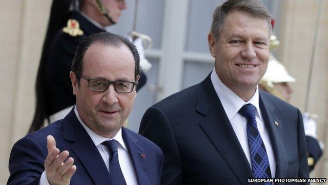 French President Francois Hollande (l) greets Romanian President Klaus Iohannis (r) as he arrives at Elysee Palace, in Paris, 10 February 2015