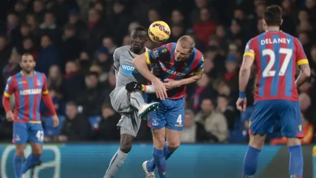 Crystal Palace's Brede Hangerlaand and Newcastle's Papiss Cisse battle for the ball