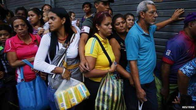 Shoppers line up to buy basic items in downtown Caracas