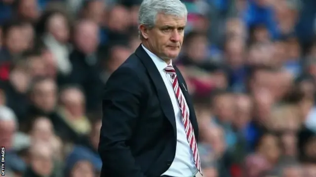 Mark Hughes looks on