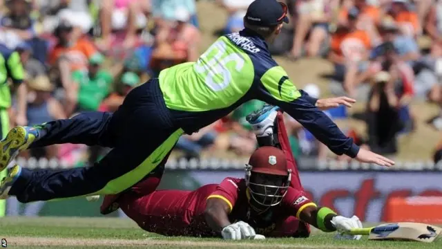 West Indie' Darren Sammy slides into his crease