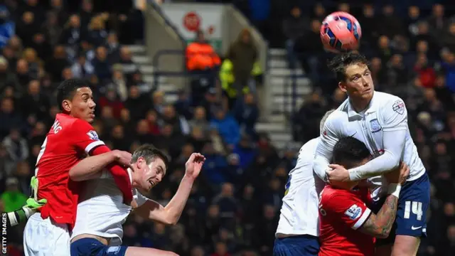 Preston's Joe Garner rises for a long ball