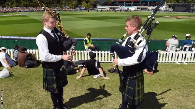 Two pipers play the bagpipes as New Zealand play Scotland