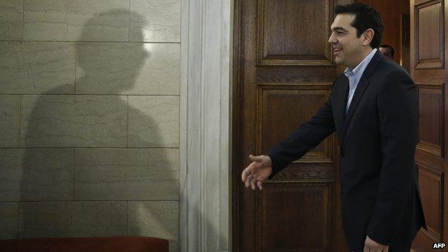 Greek Prime Minister Alexis Tsipras welcomes Eurogroup President Jeroen Dijsselbloem (not pictured) during their meeting in Athens on 30 January 2015