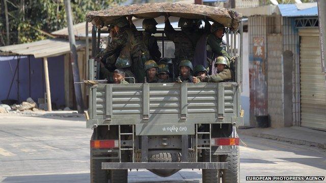 Soldiers pass along a deserted road at self-administered Kokang capital Laukkai, on 7 February 2015