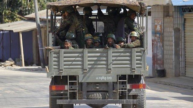 Soldiers pass along a deserted road at self-administered Kokang capital Laukkai, on 7 February 2015