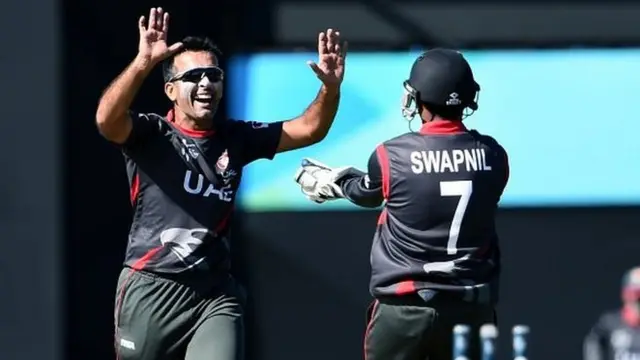 United Arab Emirates (UAE) spinner Mohammad Tauqir (L) celebrates with teammate Swapnil Patil