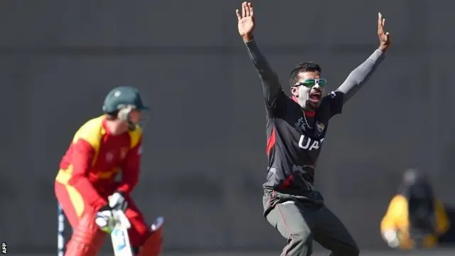 United Arab Emirates (UAE) bowler Nasir Aziz (R) traps Zimbabwe batsman Brendan Taylor