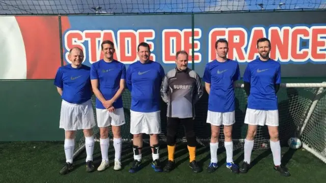 5-a-side team in front of a Stade de France banner