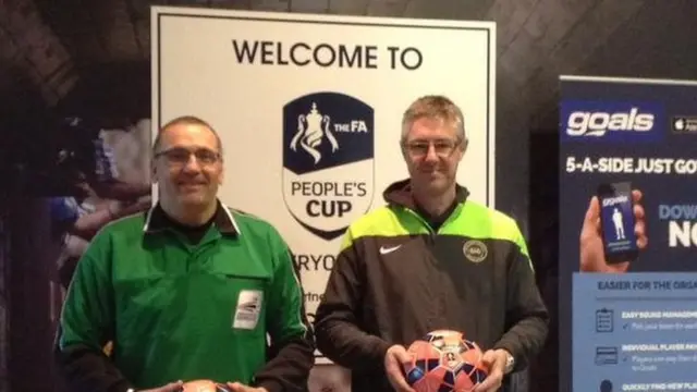 Refferees in front of an FA Peoples cup welcome board