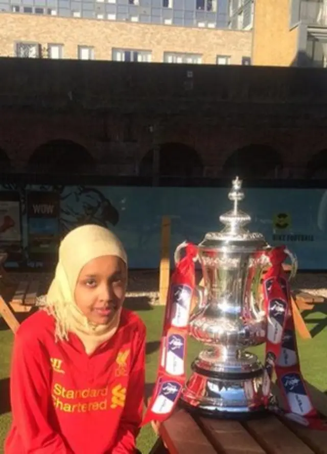 girl sat next to the FA Cup