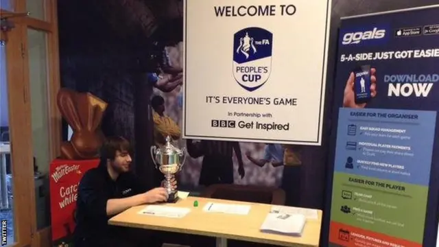 People's Cup welcome area with man and trophy