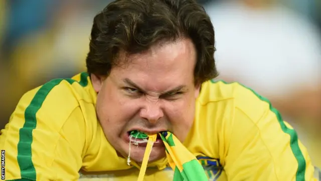 A Brazil fan eats his flag