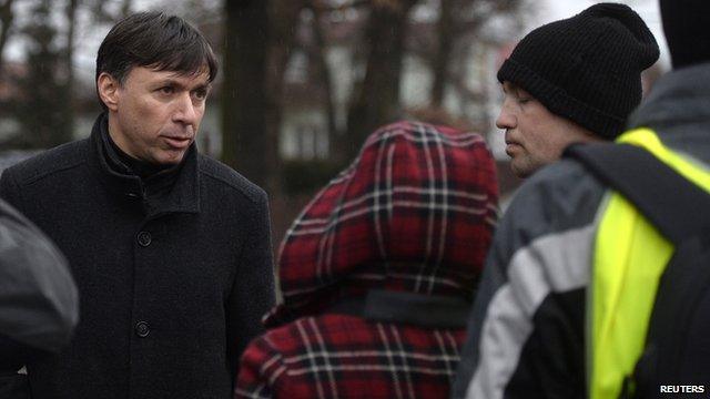 Patrik Kuncar (L), mayor of Uhersky Brod, speaks with a citizen near a restaurant where a gunman opened fire ion 24 February 24