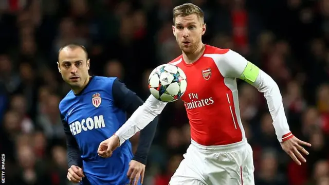 Arsenal defender Per Mertesacker holds off Monaco's Dimitar Berbatov