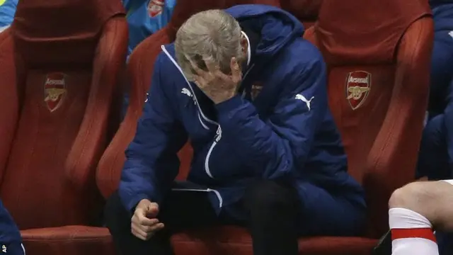 Arsenal manager Arsene Wenger holds his head in his hand