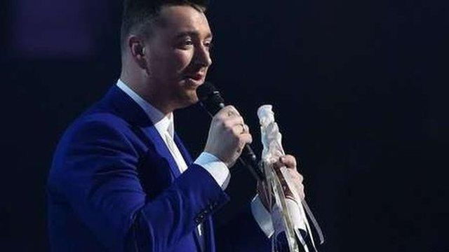 Sam Smith with an award