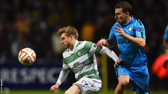 Celtic's Stuart Armstrong vies for the ball with Inter's Hugo Campagnaro