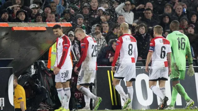 Supporters throw beer as players of Feyenoord leave the pitch