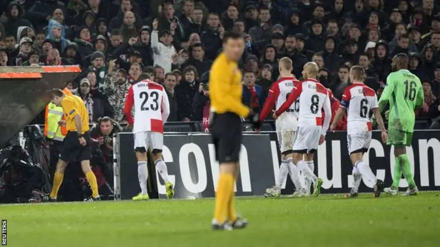 Feyenoord players walk off the pitch