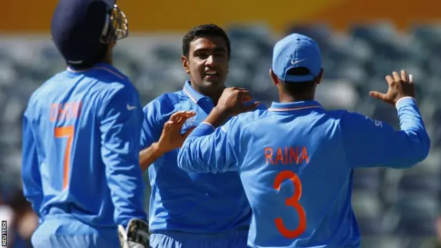 Suresh Raina, right, celebrates taking the wicket